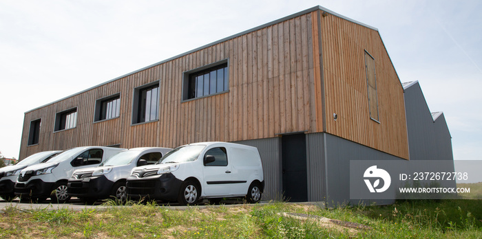 Loading delivery vans in front of cargo doors warehouse for delivery