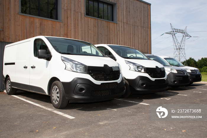 delivery van small trucks line up park outside