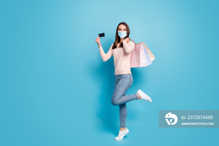 Full length view of girl jumping carrying new things credit card wear mask isolated shine vibrant bl