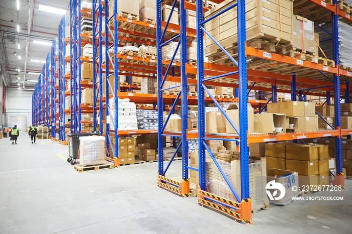 Huge distribution warehouse with high shelves and loaders.