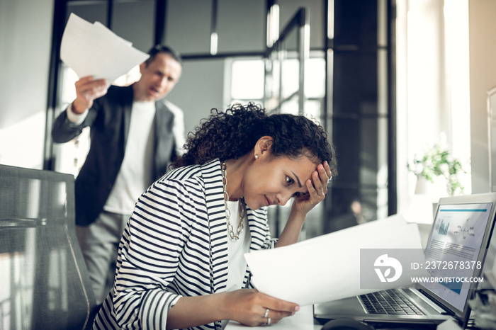 Dark-eyed employee feeling guilty for not completing the task