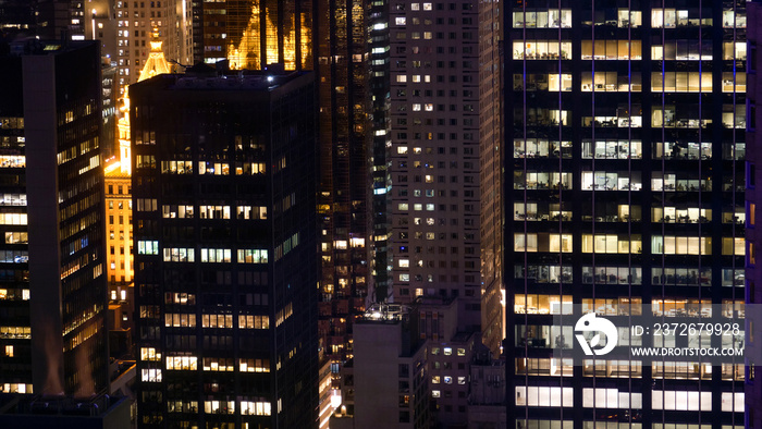 CLOSE UP: Businesspeople in offices working late into the night on busy workday.