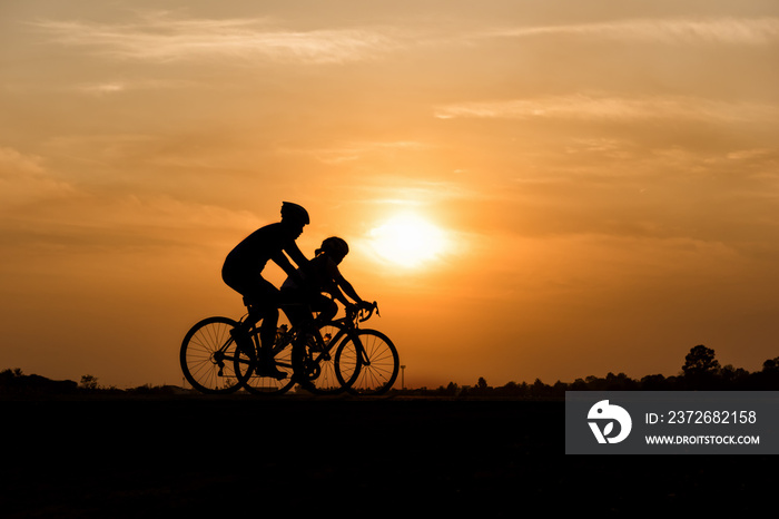 Silhouette of cycling on sunset background