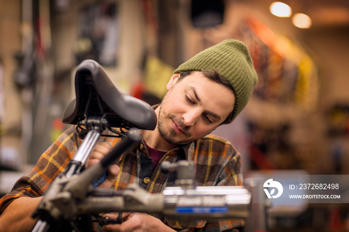 Mid-adult man repairing bicycle