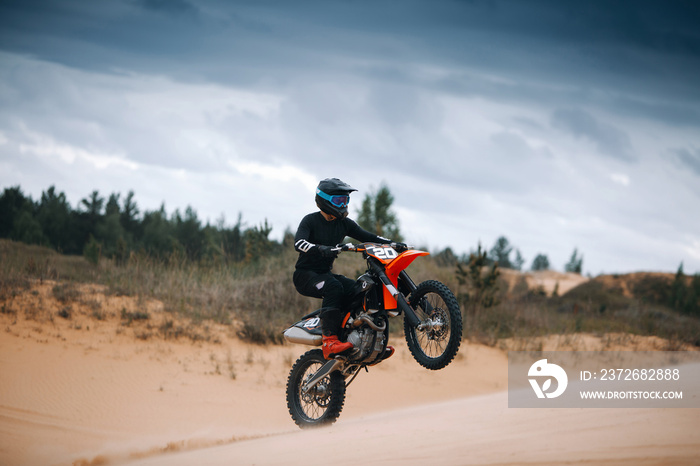 Riding on one wheel motorcycle at the desert