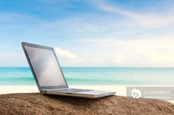 Working with a laptop on the beach