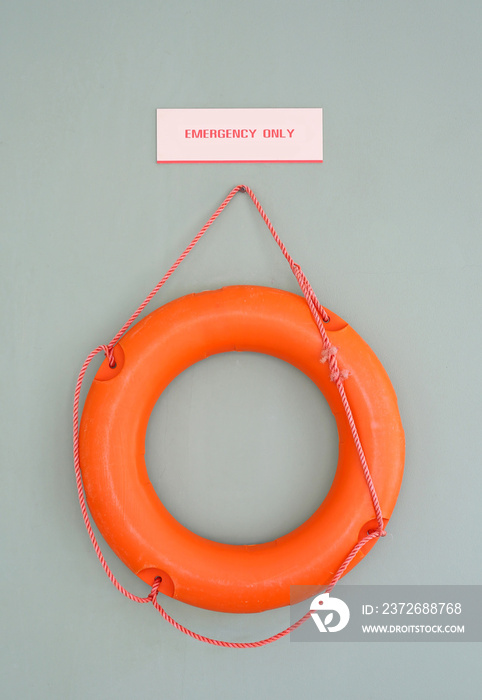 Orange Lifebuoy on a Gray Wall Background