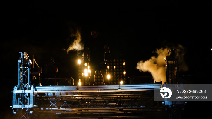 Fight night, profesional athletes.Fighter enters the ring. Lighting effects, smoke, a platform to sh