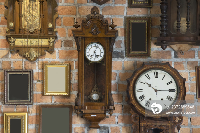 挂在砖墙上的复古时钟和相框收藏