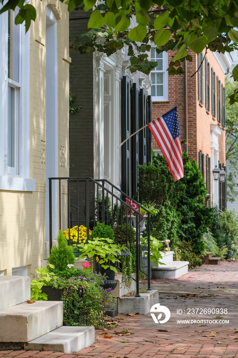 Beautiful picturesque New England style house facades in historic Old Town Alexandria, Virginia with