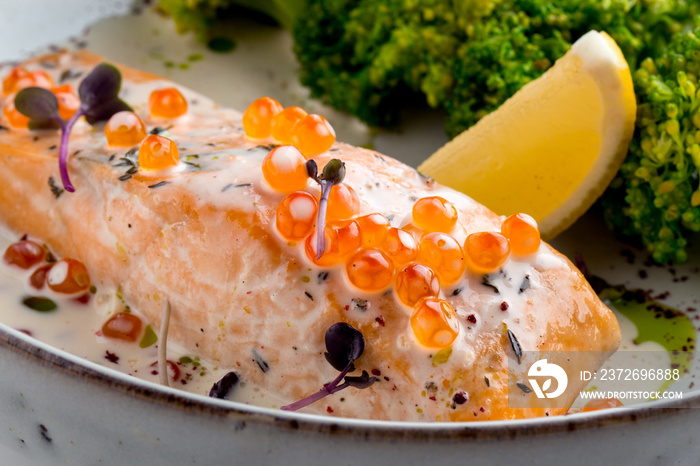 Festive dish salmon with roe lemon and broccoli