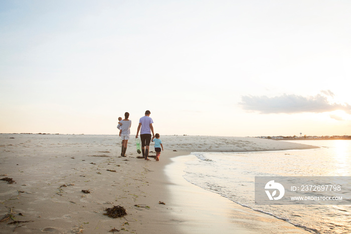 Family with two children (0-1 month, 2-3 years) on beach