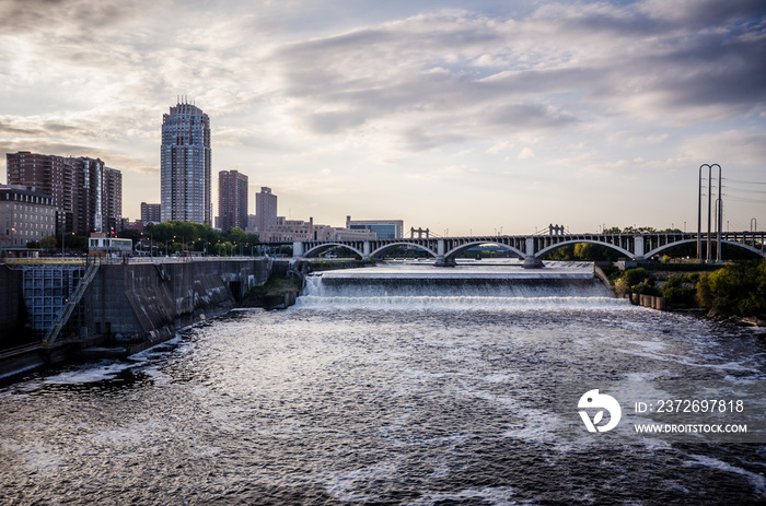 Sunset dusk view of Minneapolis Minnesota skyline as seen from the Mississippi River. 35W Bridge in 