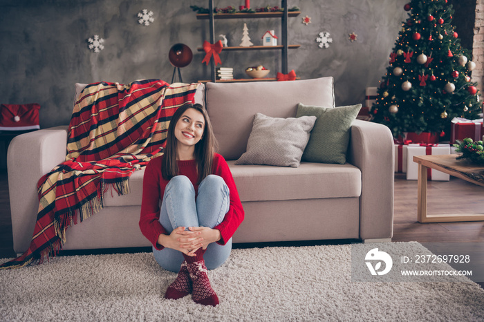 Photo of charming girl sitting carpet couch look up embrace legs wear red pullover socks jeans in de