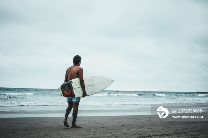 surfer boy in montañita beaches, ecuador