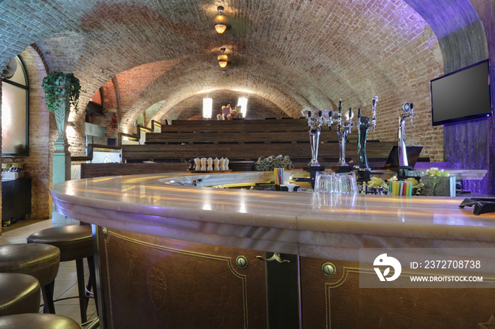 Wooden bar close-up against rows of tiered seats