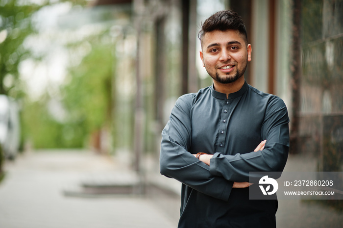 Сonfident pakistani indian muslim arabic boy in grey kameez shalwar suit.