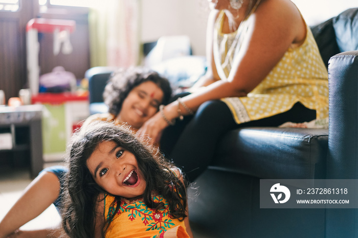 Happy indian family having fun at home sitting on sofa - India Religion, love, hindu ethnicities and