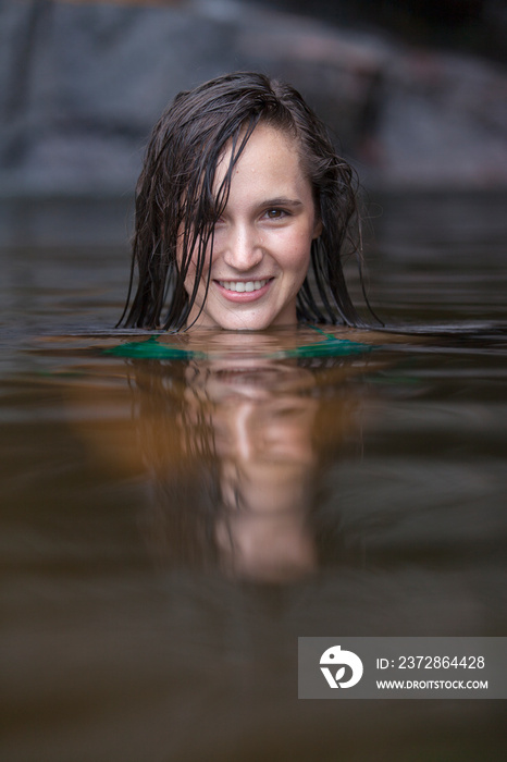 Portrait beautiful young woman swimming in lake