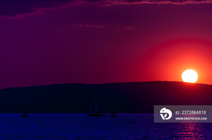 Synthwave themed colorful sunet over the Balaton lake