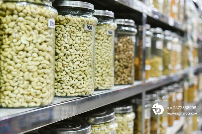 Cashew nuts in glass Jar for sale. Many raw and processed nuts Kerala, India. Whole, salted Anacardi