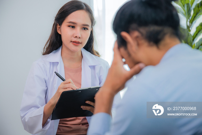 Asian woman professional psychologist doctor write, note on paper and giving the consult to man patients in room of house or hospital exam room, Mental health Concept, Doctor of Advisors concept