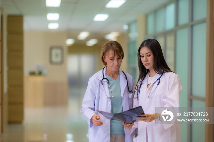 Two female doctor discussion the x-ray film in the hospital