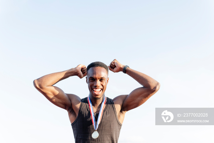 Portrait of athlete celebrating with medal