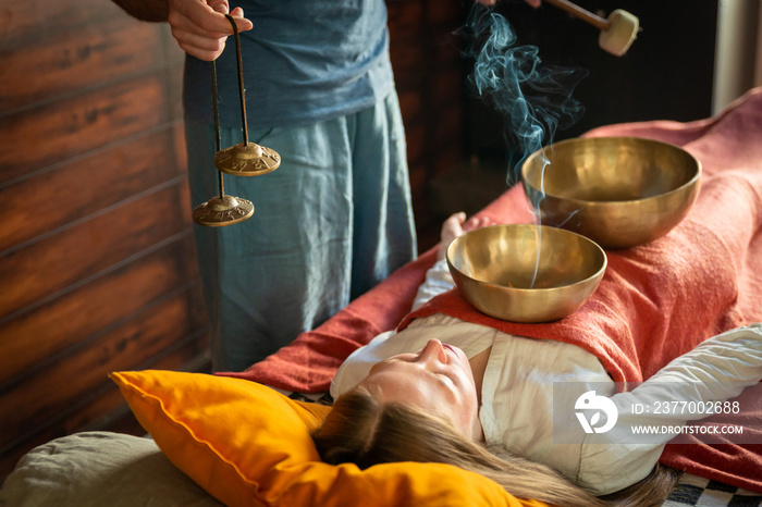 Sound massage, Tibetan singing bowls treatment in spa salon