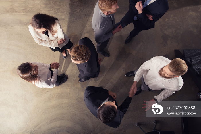 Handshaking business person in office. concept of teamwork and partnership. double exposure