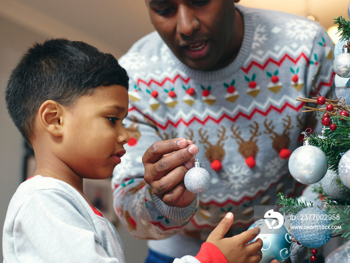 Father and son decorating Christmas tree