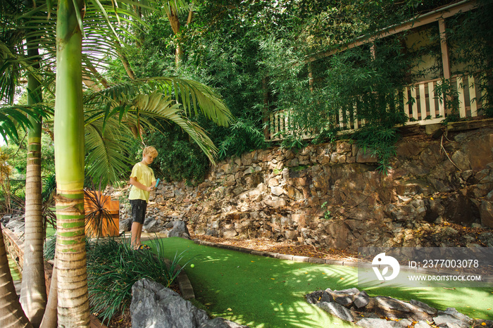 Kids playing mini golf at the Big Banana fun park, Coffs Harbour Australia