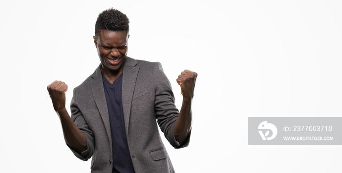 Young african american man wearing a jacket screaming proud and celebrating victory and success very excited, cheering emotion