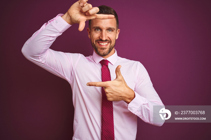 Young business man wearing elegant shirt and tie over purple isolated background smiling making frame with hands and fingers with happy face. Creativity and photography concept.