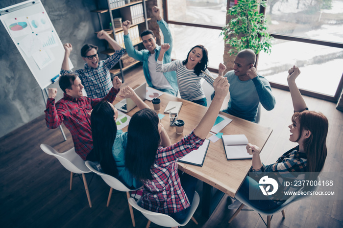 Above high angle view of nice attractive beautiful handsome cheerful executive managers wearing casual sitting rejoice at industrial loft interior workplace workstation open space indoors