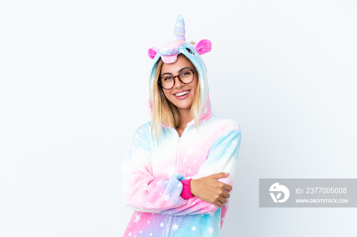 Blonde Uruguayan girl wearing a unicorn pajama isolated on white background with glasses and smiling