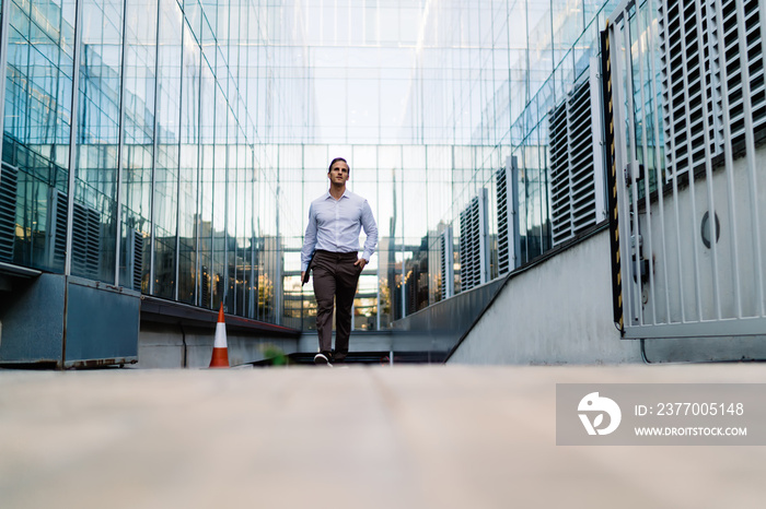 Confident man walking out of underground crossing