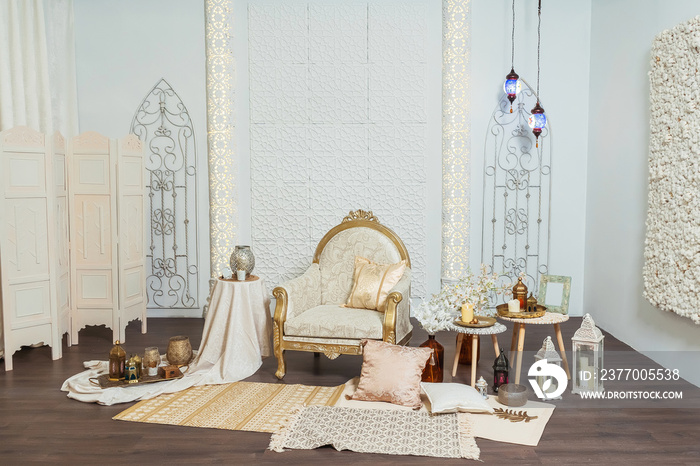 White and gold interior chair and tables in Oriental style. Moroccan middle East Decoration in Eastern Arabic style design. White room in Oriental style