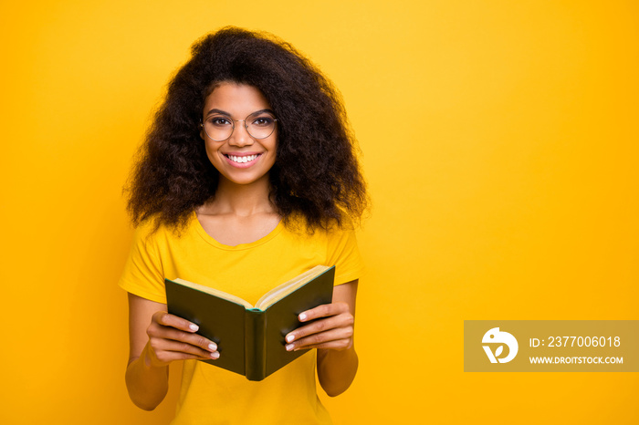 Close-up portrait of her she nice attractive lovely charming intellectual cheerful cheery wavy-haired girl nerd reading diary isolated on bright vivid shine vibrant yellow color background