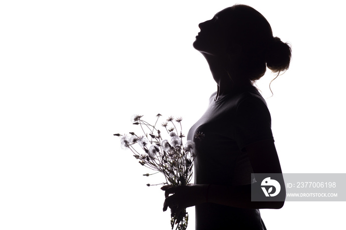 silhouette of a girl with a bouquet of dry dandelions looking up, the face profile of a young woman on a white isolated background,