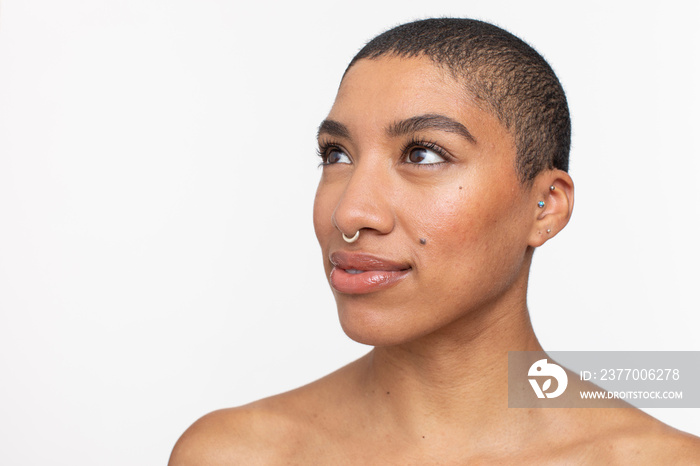 Studio portrait of woman with short hair and nose ring