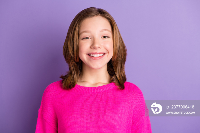 Photo of happy charming small girl wear pink sweater smile good mood isolated on violet color background