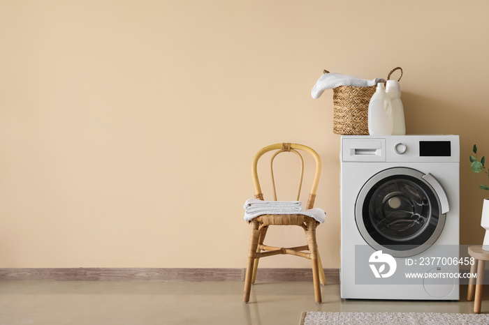 Interior of laundry room with washing machine, chair and stool