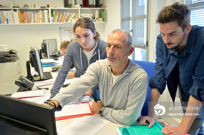 Young people in design office with instructor