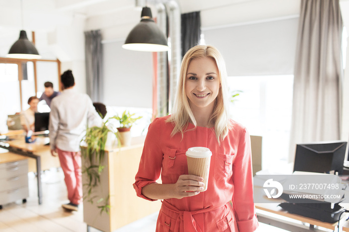 happy creative woman with coffee cup at office