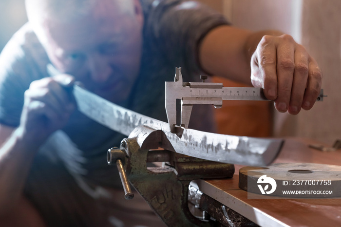 Katana sword making. Measuring control of kissaki blade thickness.