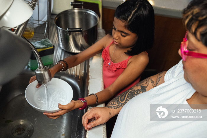 Children helping their parents wash up after dinner