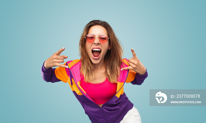 Young woman gesturing rock sign