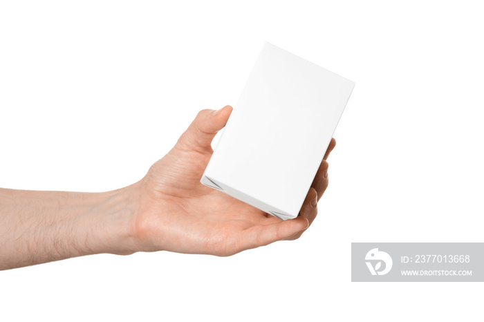 White box in a male hand, without inscriptions, isolate on a white background.