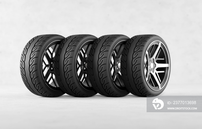 Four tires on the concrete floor. Concept of buying tires for a car, a motorbike.